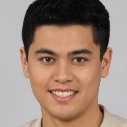 Joyful latino young-adult male with short  brown hair and brown eyes