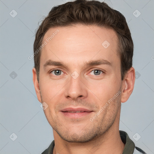 Joyful white young-adult male with short  brown hair and grey eyes