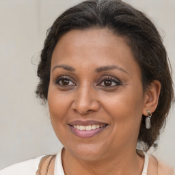 Joyful black adult female with medium  brown hair and brown eyes