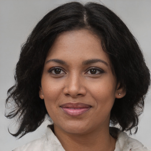 Joyful black young-adult female with medium  black hair and brown eyes