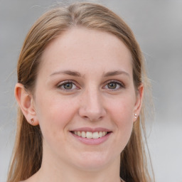 Joyful white young-adult female with medium  brown hair and blue eyes