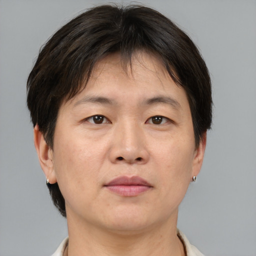 Joyful asian adult male with short  brown hair and brown eyes