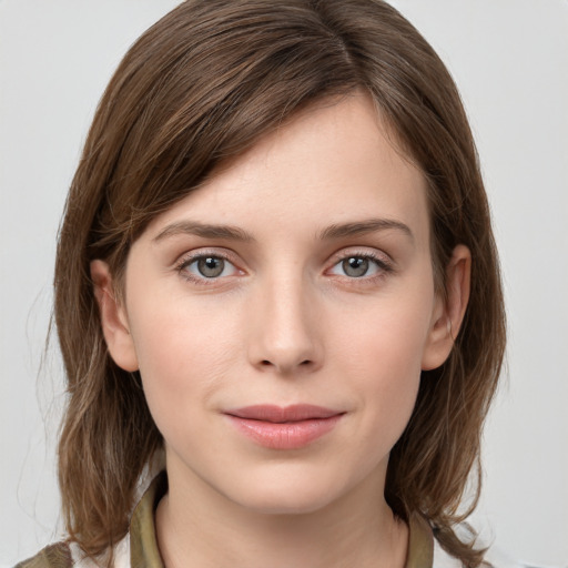 Joyful white young-adult female with medium  brown hair and grey eyes