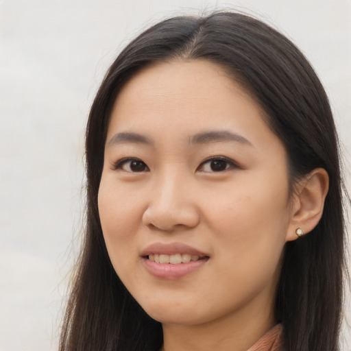 Joyful asian young-adult female with long  brown hair and brown eyes