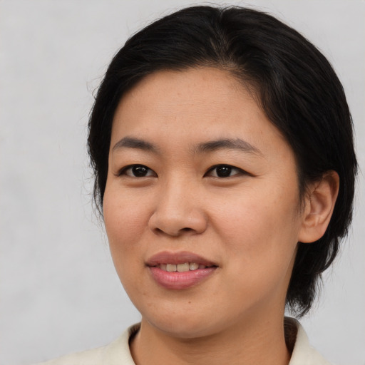 Joyful asian young-adult female with medium  brown hair and brown eyes