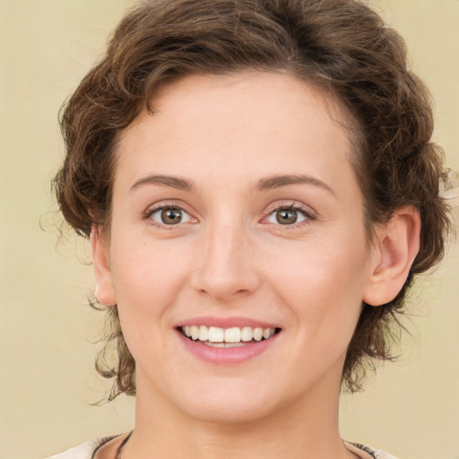 Joyful white young-adult female with medium  brown hair and green eyes