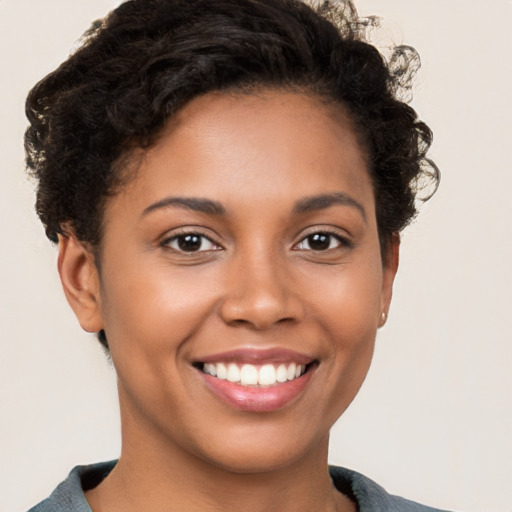 Joyful latino young-adult female with short  brown hair and brown eyes