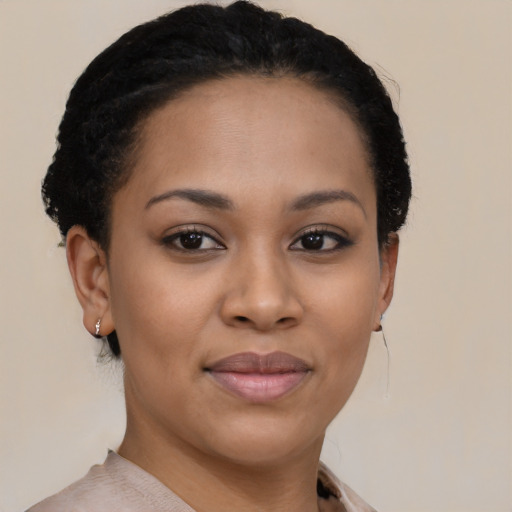 Joyful black young-adult female with short  brown hair and brown eyes