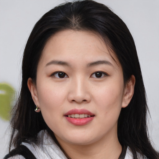Joyful asian young-adult female with long  brown hair and brown eyes