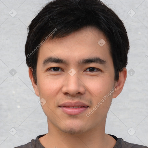 Joyful asian young-adult male with short  black hair and brown eyes