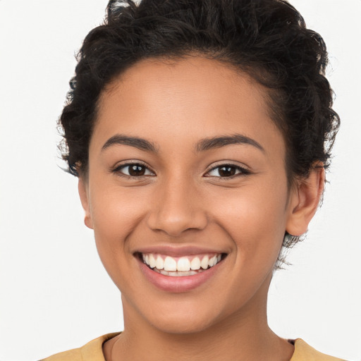 Joyful latino young-adult female with short  brown hair and brown eyes