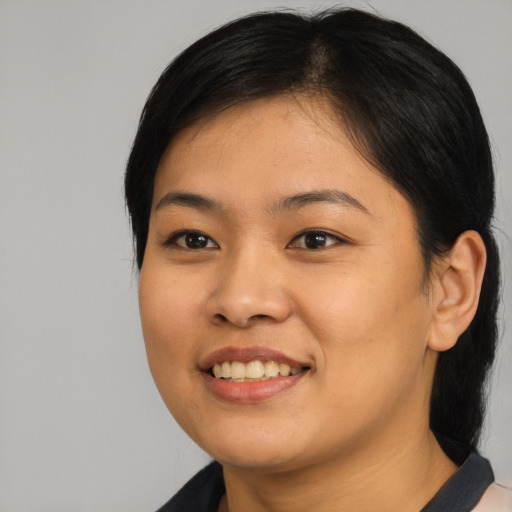 Joyful asian young-adult female with medium  black hair and brown eyes