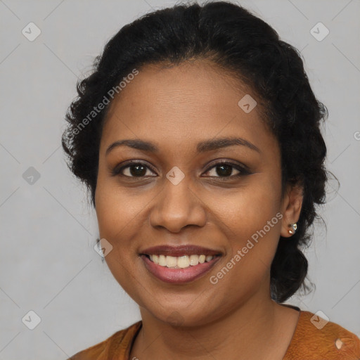 Joyful black young-adult female with long  brown hair and brown eyes