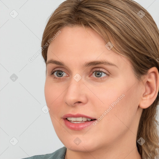 Joyful white young-adult female with medium  brown hair and blue eyes