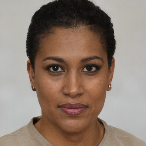 Joyful black young-adult female with short  brown hair and brown eyes