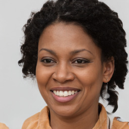 Joyful black adult female with medium  brown hair and brown eyes