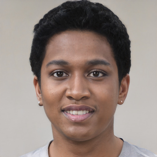 Joyful black young-adult female with short  black hair and brown eyes
