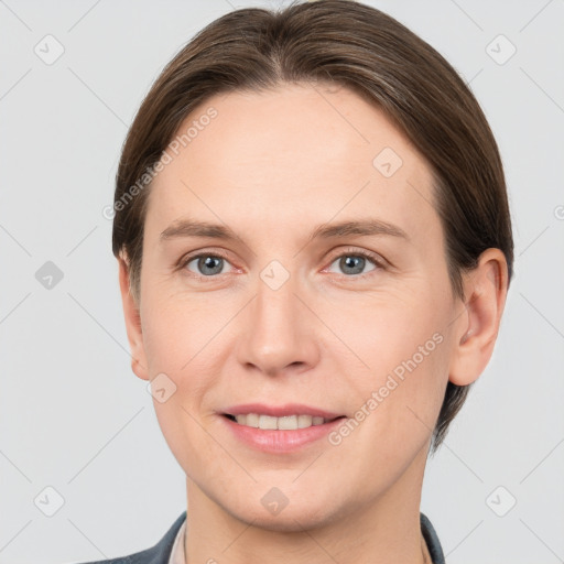 Joyful white young-adult female with short  brown hair and grey eyes