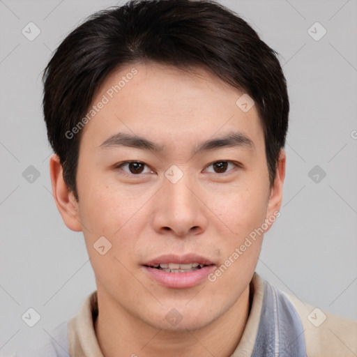 Joyful asian young-adult male with short  brown hair and brown eyes