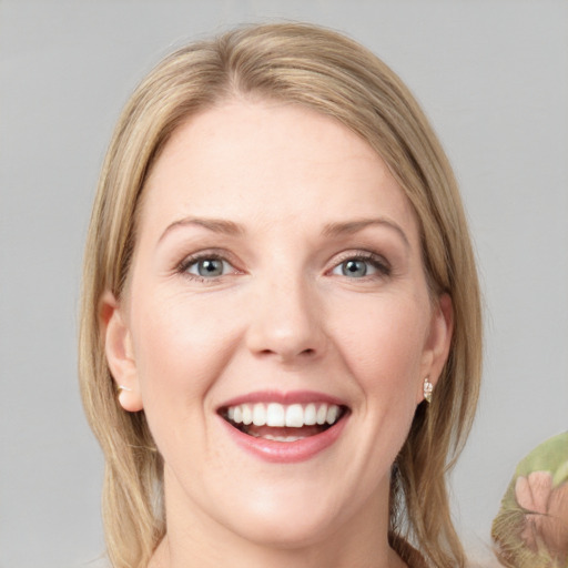 Joyful white young-adult female with medium  brown hair and green eyes