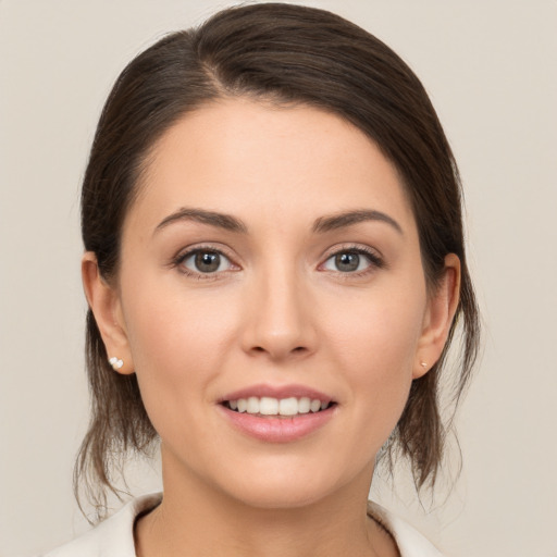 Joyful white young-adult female with medium  brown hair and brown eyes