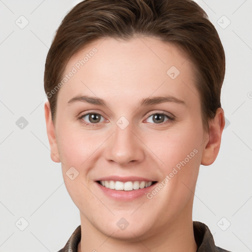 Joyful white young-adult female with short  brown hair and grey eyes