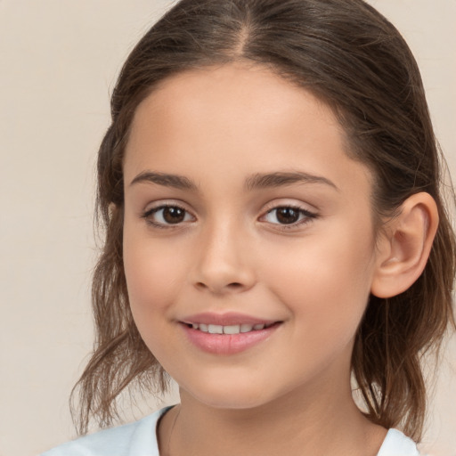 Joyful white child female with medium  brown hair and brown eyes