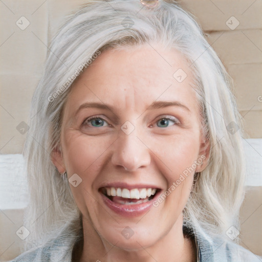 Joyful white adult female with medium  blond hair and blue eyes