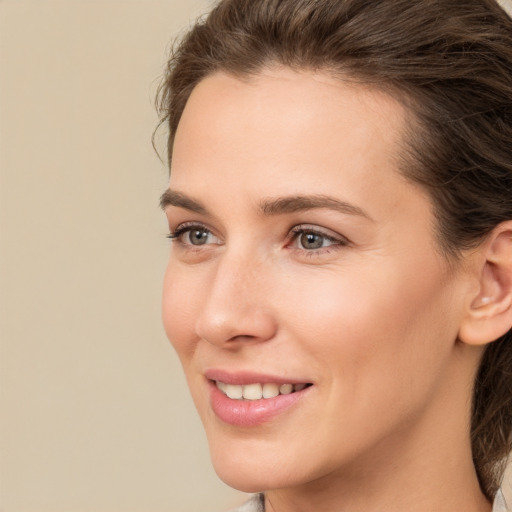 Joyful white young-adult female with medium  brown hair and brown eyes