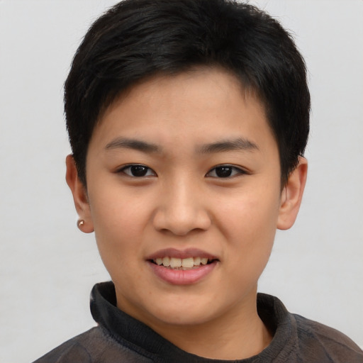Joyful asian child female with short  black hair and brown eyes