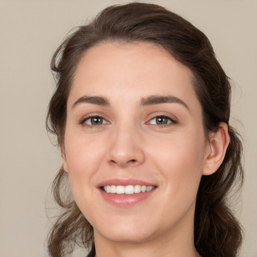 Joyful white young-adult female with medium  brown hair and brown eyes