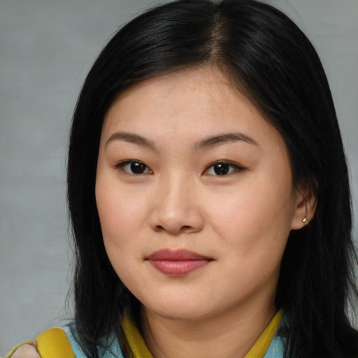 Joyful asian young-adult female with long  brown hair and brown eyes