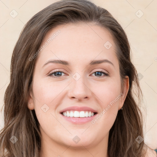 Joyful white young-adult female with long  brown hair and blue eyes