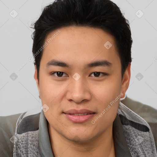 Joyful asian young-adult male with short  brown hair and brown eyes