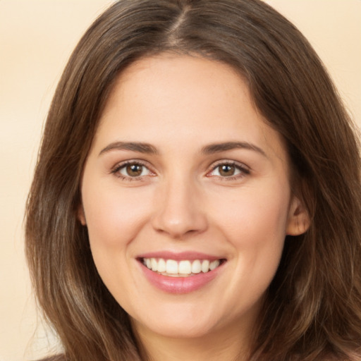 Joyful white young-adult female with long  brown hair and brown eyes