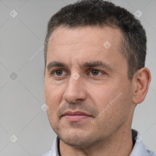 Joyful white adult male with short  brown hair and brown eyes