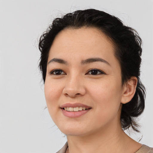 Joyful white young-adult female with medium  black hair and brown eyes