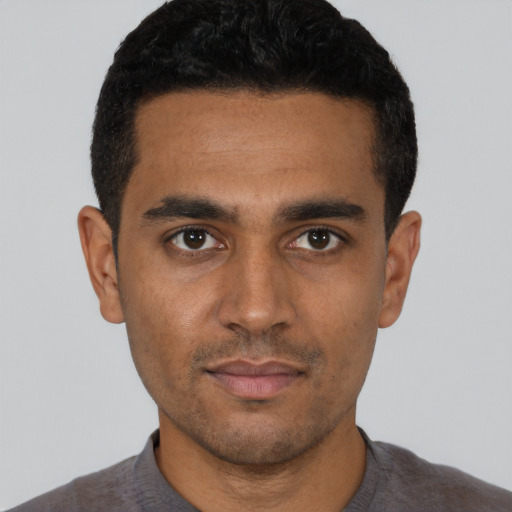 Neutral latino young-adult male with short  black hair and brown eyes