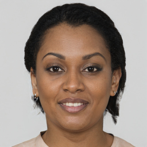 Joyful black young-adult female with short  black hair and brown eyes