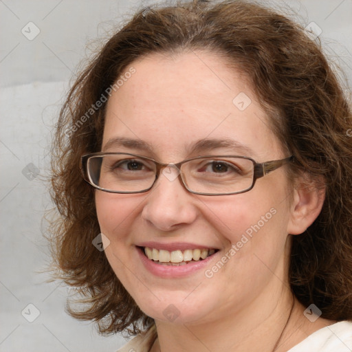 Joyful white adult female with medium  brown hair and blue eyes