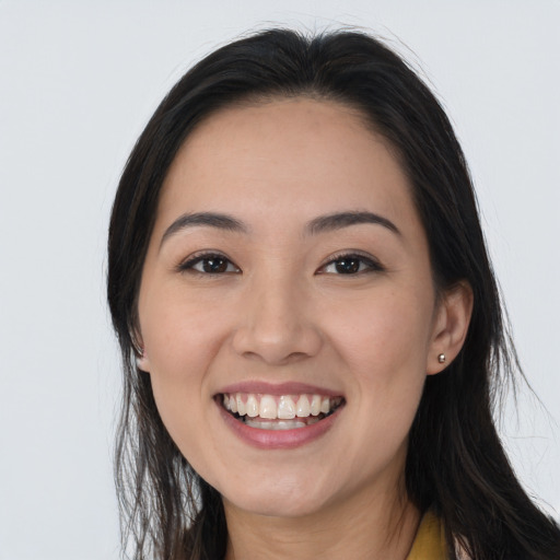 Joyful white young-adult female with long  black hair and brown eyes