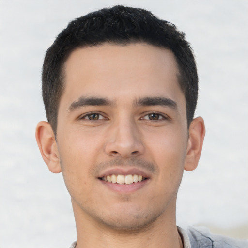Joyful asian young-adult male with short  black hair and brown eyes
