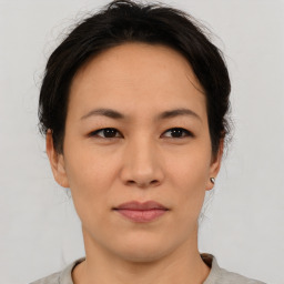 Joyful asian young-adult female with short  brown hair and brown eyes