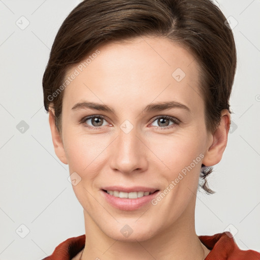 Joyful white young-adult female with short  brown hair and grey eyes