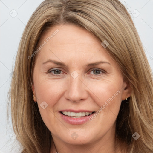 Joyful white adult female with long  brown hair and brown eyes