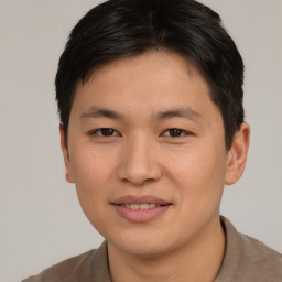 Joyful asian young-adult male with short  brown hair and brown eyes