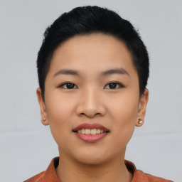 Joyful asian young-adult female with short  black hair and brown eyes