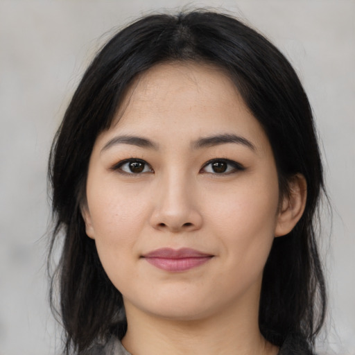 Joyful asian young-adult female with long  black hair and brown eyes