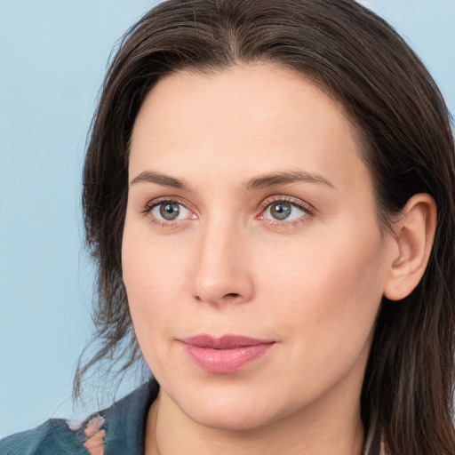 Joyful white young-adult female with long  brown hair and grey eyes