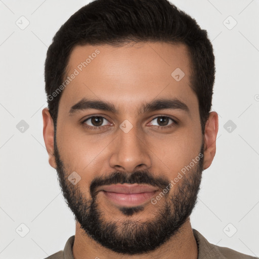 Joyful latino young-adult male with short  brown hair and brown eyes